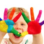 Happy child with painted hands