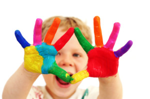 child with coloured hands