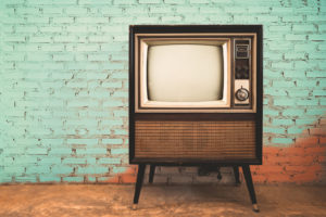 Retro old television in vintage wall pastel color background