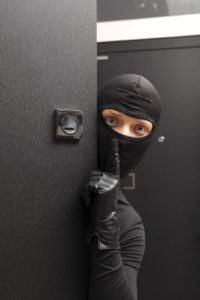 Ninja. Robber hiding behind a door with space for text