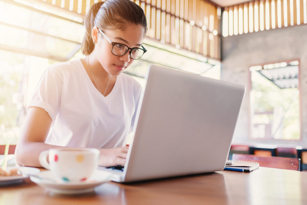 Woman writing on a laptop