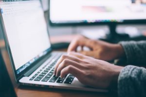 hands on laptop keyboard