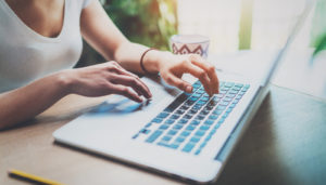 laptop woman writing