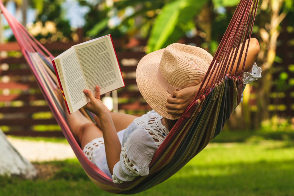 woman reading in a hammock