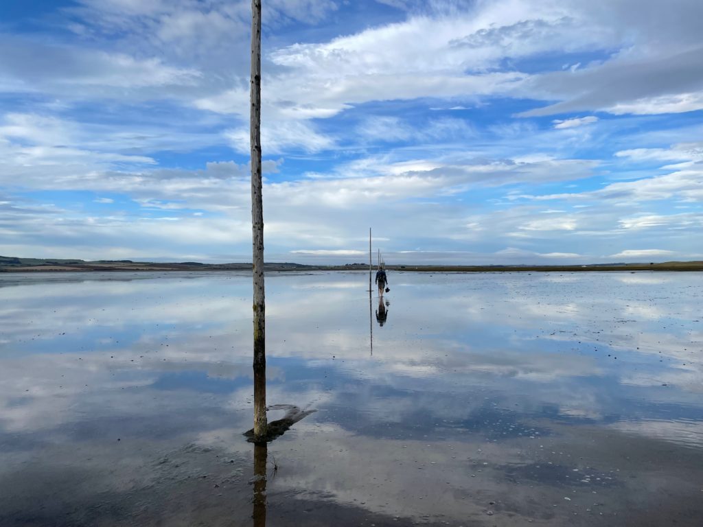 Walking across the sands to Lindisfarne, Holy Island on the St Cuthbert's Way